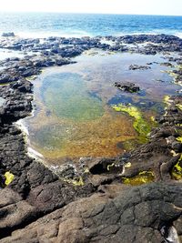 High angle view of rocks on beach against sky