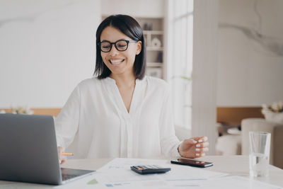 Portrait of young businesswoman working in office