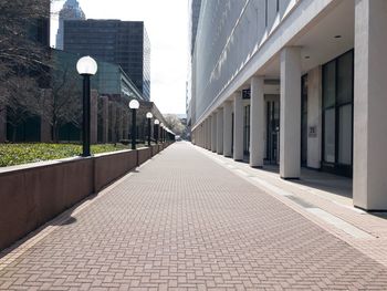 Empty street amidst buildings in city