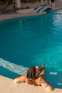 Woman relaxing on swimming pool