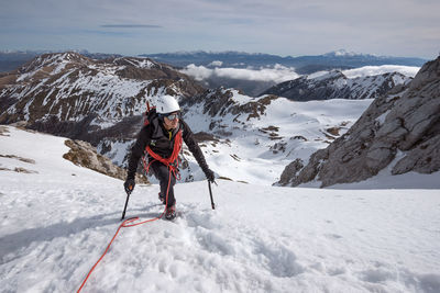 Person on snowcapped mountains during winter