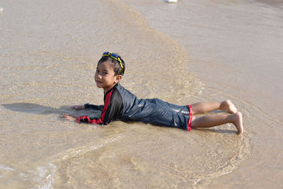 Boy looking at sea shore