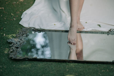 Low section of woman standing on ground