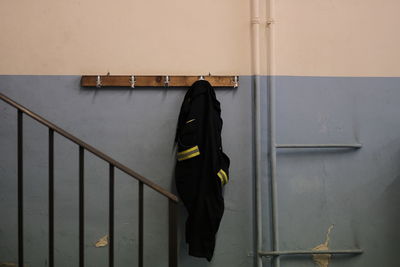 Rear view of person standing on staircase against building