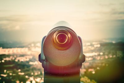 Close-up of coin-operated binoculars against sky