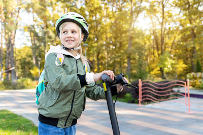 Portrait of boy standing in park