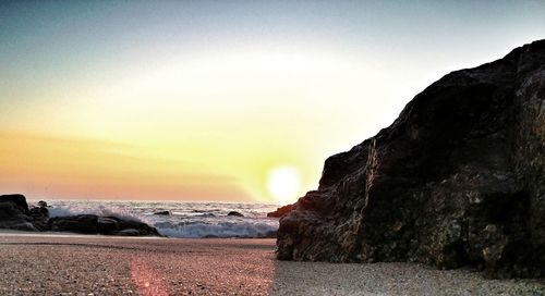 Scenic view of beach against sky during sunset