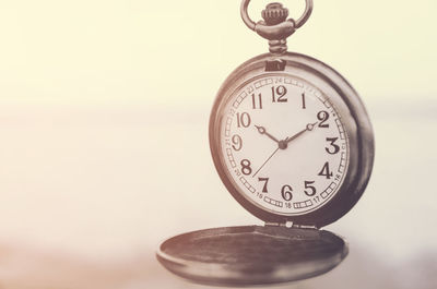 Close-up of pocket watch on table