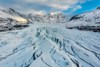 Scenic view of snowcapped mountains against sky