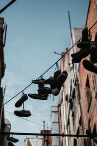 Low angle view of shoes hanging on cable