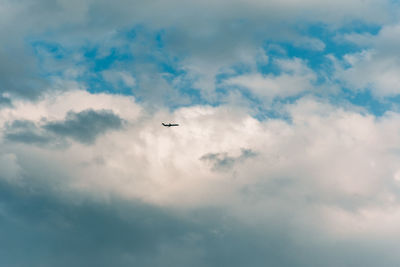 Low angle view of airplane flying in sky