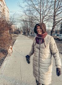 Portrait of smiling young woman standing in winter