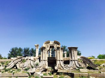 Old ruins of summer palace against blue sky on sunny day