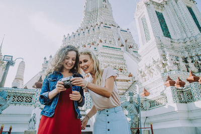 Happy women at temple in city