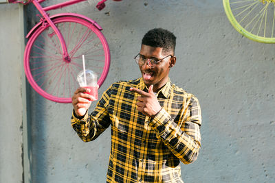 Side view of young man using mobile phone