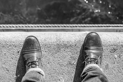 Low section of person standing on road