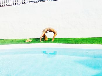 Man in swimming pool against sky