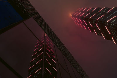 Low angle view of illuminated building against sky at night