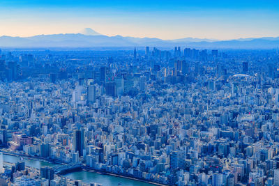 Aerial view of city buildings against sky