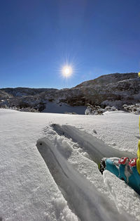 Scenic view of snow covered mountains against blue sky