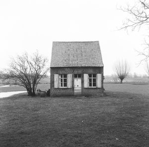 Abandoned house on field against clear sky