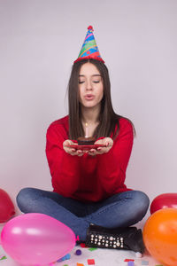 Portrait of a beautiful young woman sitting at home