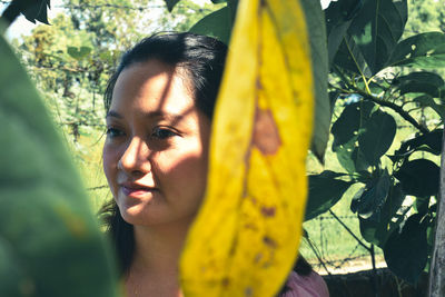 Portrait of woman against yellow plants