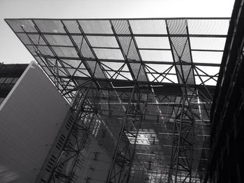 Low angle view of glass building against sky