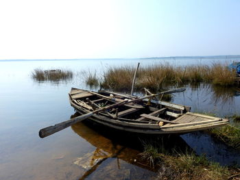 Boat moored in sea against clear sky