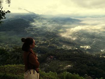 Side view of woman looking at mountains