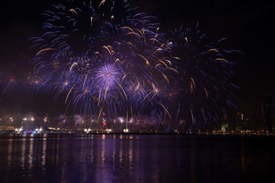 Firework display in city at night