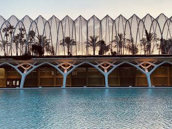Bridge by swimming pool against sky