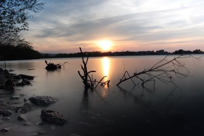 Scenic view of lake against sky during sunset