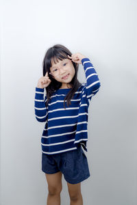 Young woman standing against white background