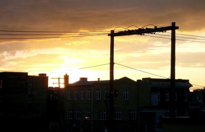 Low angle view of building against sky at sunset