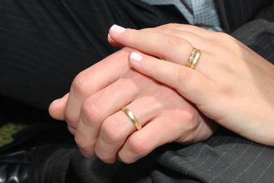 Cropped image of couple wearing engagement rings