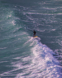 High angle view of man surfing in sea