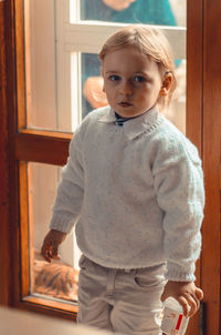 Portrait of cute boy standing at home