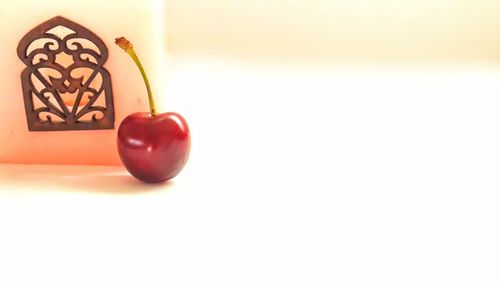 Close-up of apple on table against white background