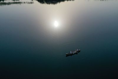 Drone shot of two women in a canoe on the lake in mazury, poland.