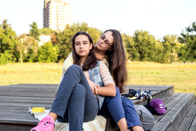 Portrait of young woman sitting on road