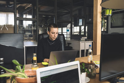 Businesswoman working over laptop at workplace