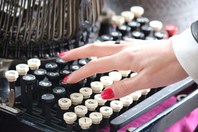 Close-up of woman hand with wine bottles