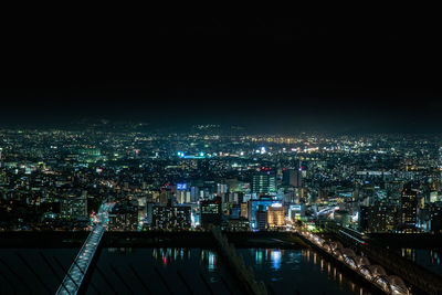 Illuminated cityscape against sky at night