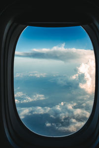 Cloudy sky seen through airplane window