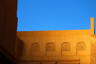 Low angle view of built structure against blue sky