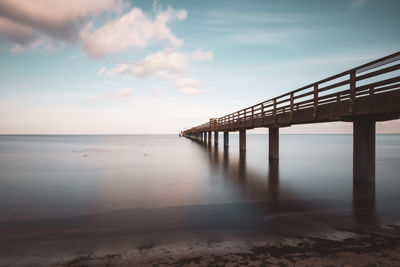 Pier over sea against sky