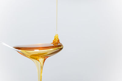 Close-up of wineglass against white background