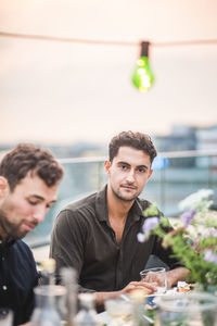 Portrait of a young man sitting at table