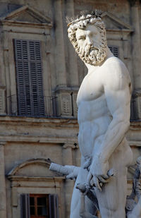 Low angle view of statue against building